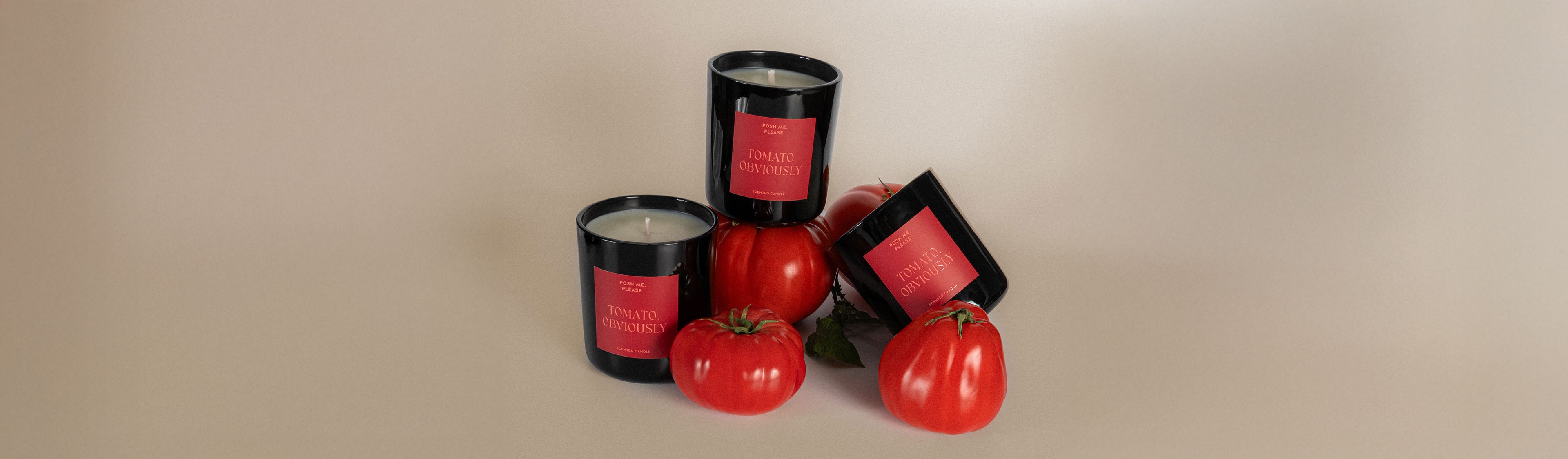 Set of black candles with red labels on a beige background