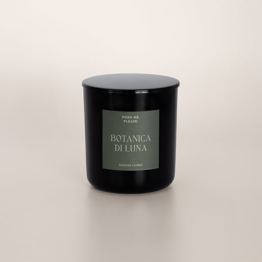Botanica di Luna black glass candle with green label by POSH ME, PLEASE., lid on, light background