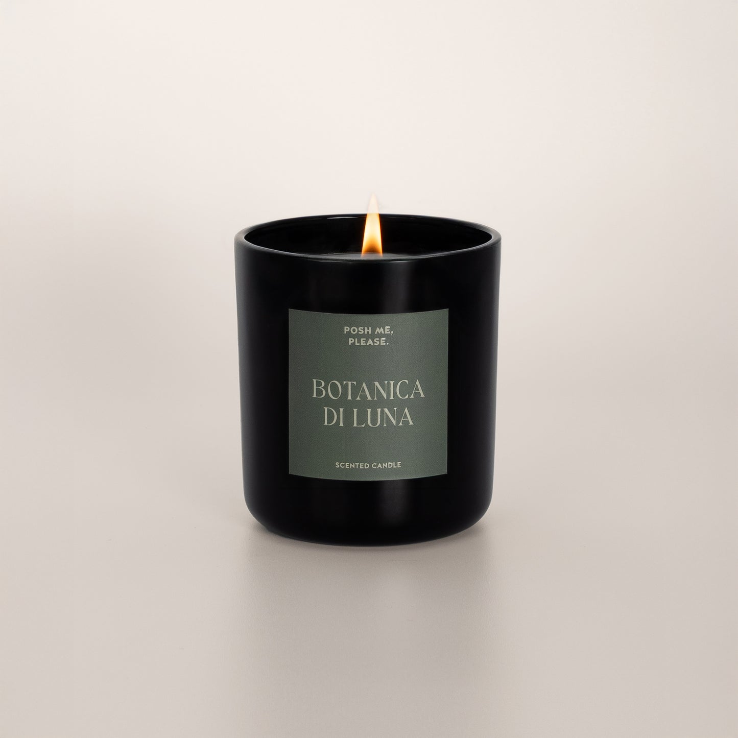 Lit Botanica di Luna candle with flame, clean coconut wax burn, neutral background