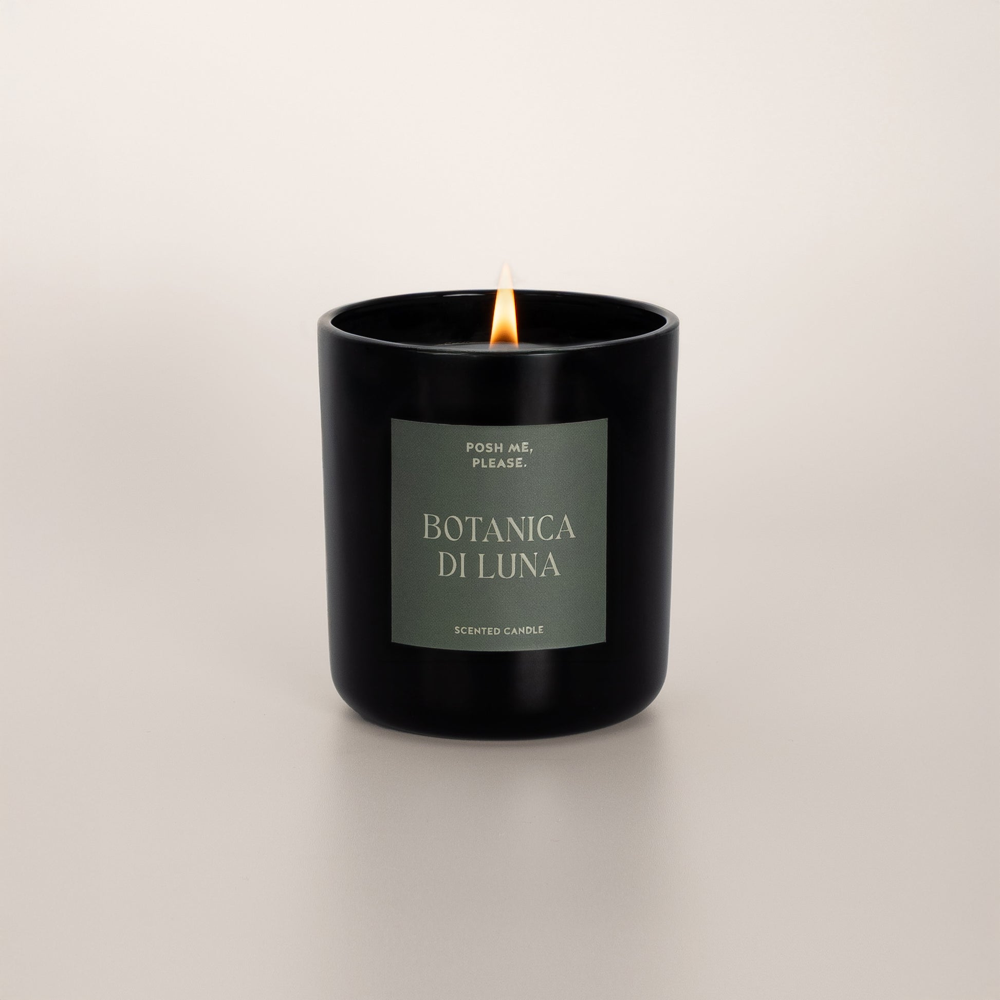 Lit Botanica di Luna candle with flame, clean coconut wax burn, neutral background