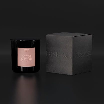 Do Not Disturb candle beside black embossed POSH ME, PLEASE. gift box, dark background