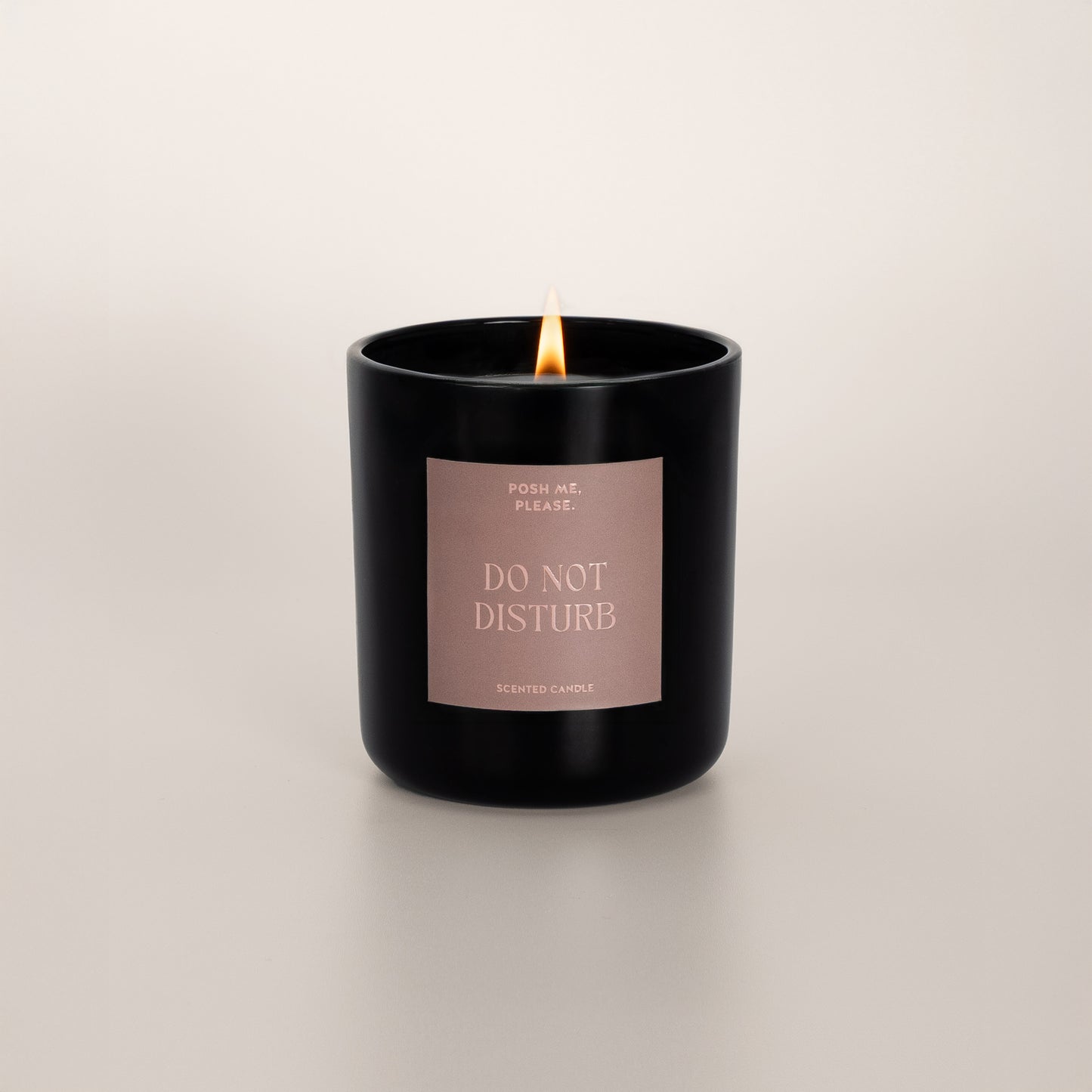 Lit Do Not Disturb candle with flame, citrus neroli scent, neutral background