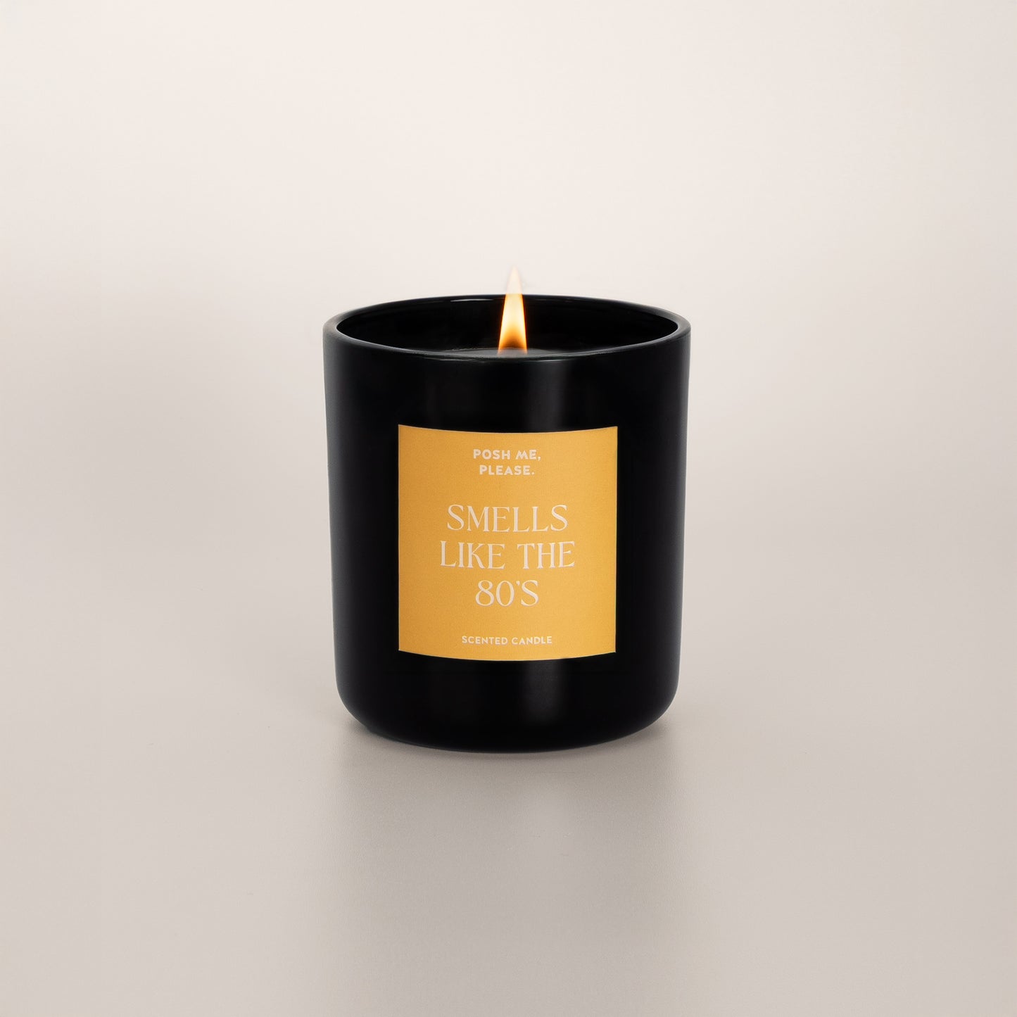 Lit Smells Like The 80s candle with flame, fruity oriental scent, neutral background