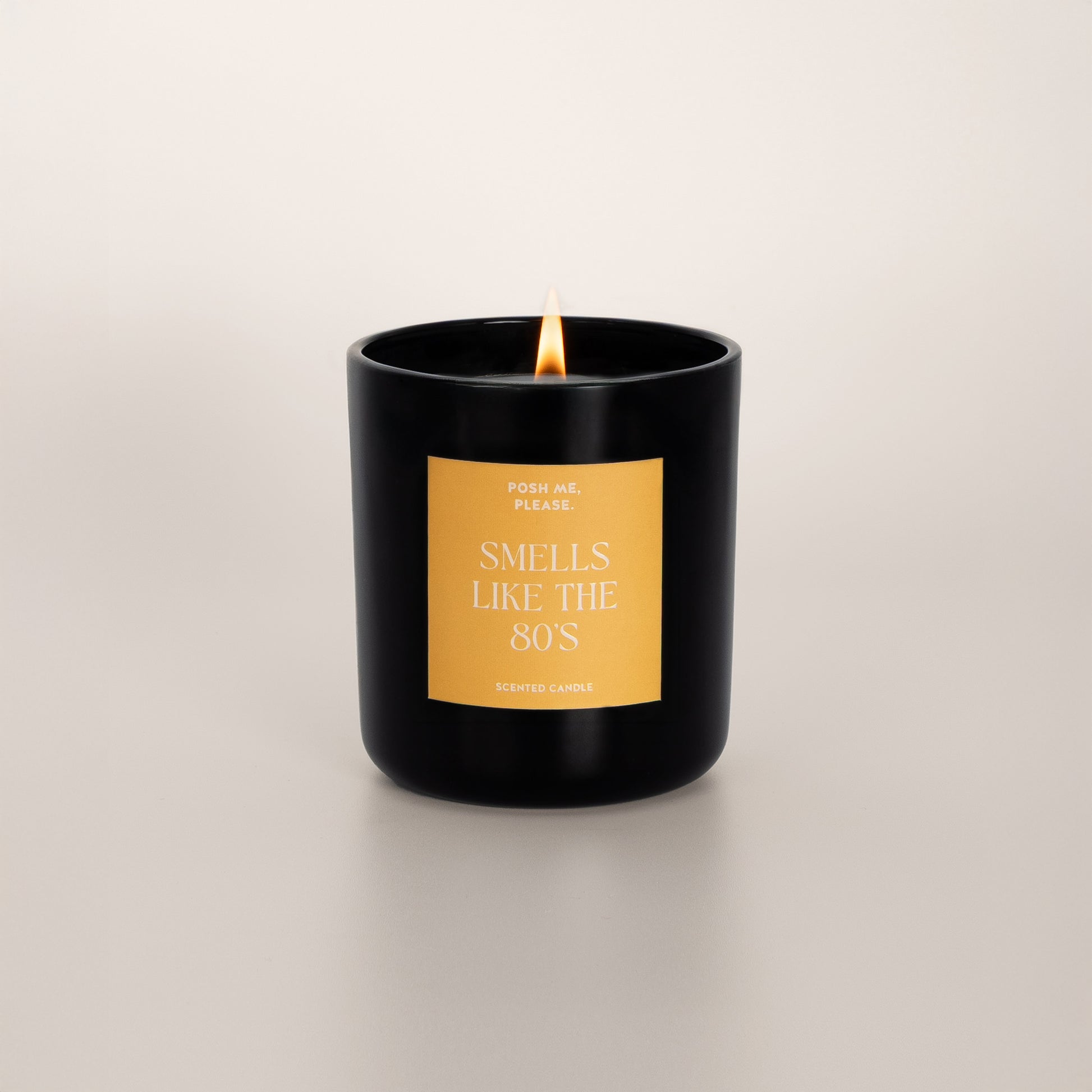 Lit Smells Like The 80s candle with flame, fruity oriental scent, neutral background