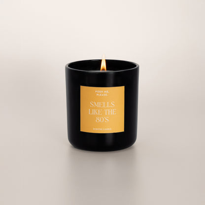 Lit Smells Like The 80s candle with flame, fruity oriental scent, neutral background