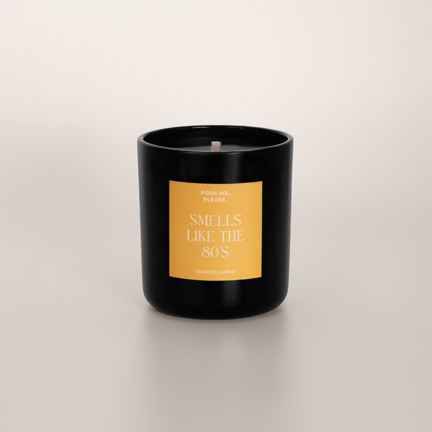 Smells Like The 80s coconut wax candle in black glass vessel, no lid, cotton wick visible