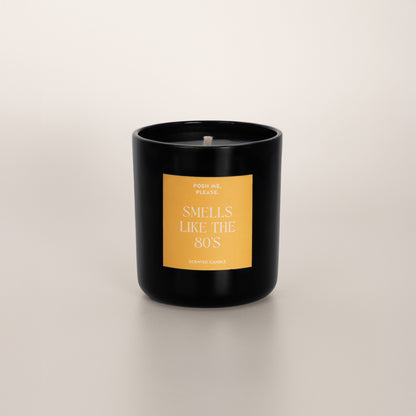 Smells Like The 80s coconut wax candle in black glass vessel, no lid, cotton wick visible