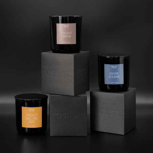 Italian Crush, Mystic Eclipse and Smells Like The 80s candles stacked on embossed POSH ME, PLEASE. black blocks, dark background