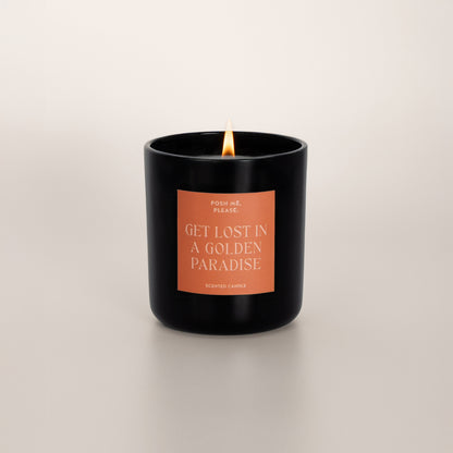 Lit Get Lost in a Golden Paradise candle with flame, pear agave vanilla scent, neutral background