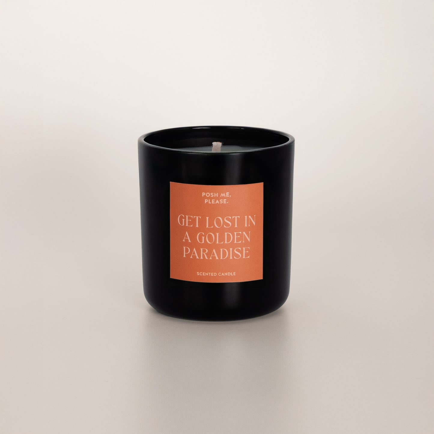 Get Lost in a Golden Paradise coconut wax candle in black glass vessel, no lid, cotton wick visible