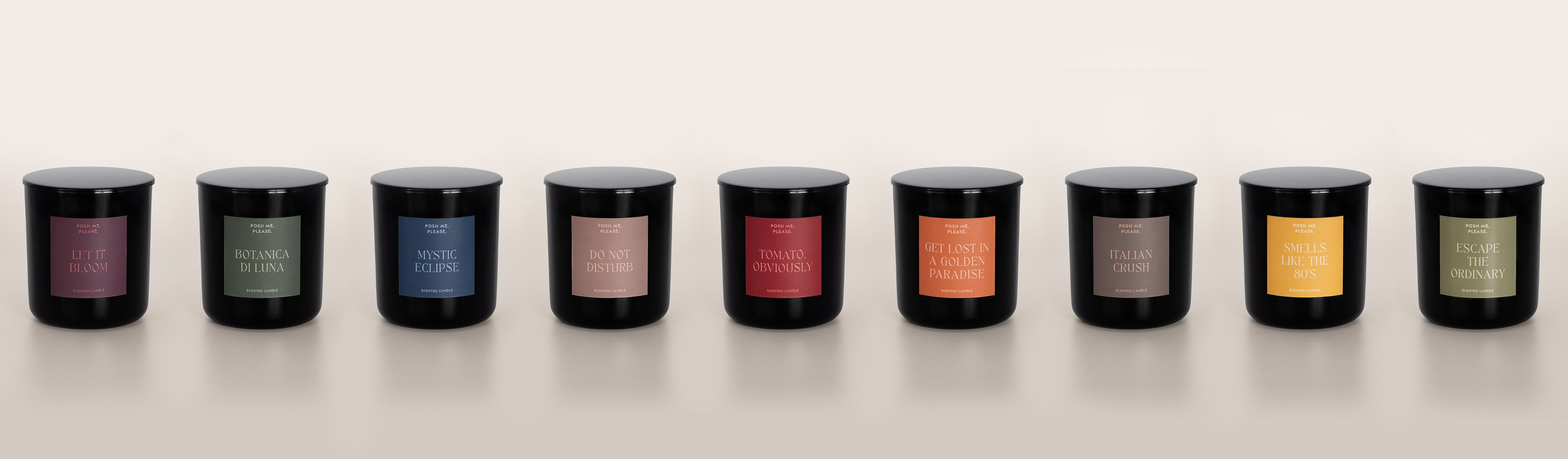Nine POSH ME, PLEASE. scented candles lined up in black glass vessels, Aura Collection