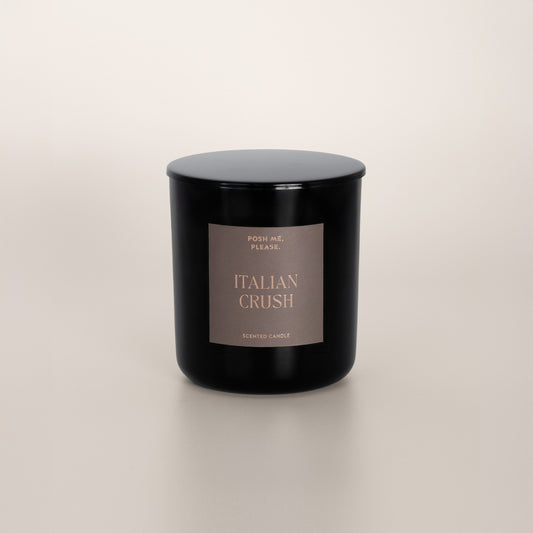 Italian Crush black glass candle with warm grey label by POSH ME, PLEASE., lid on, light background