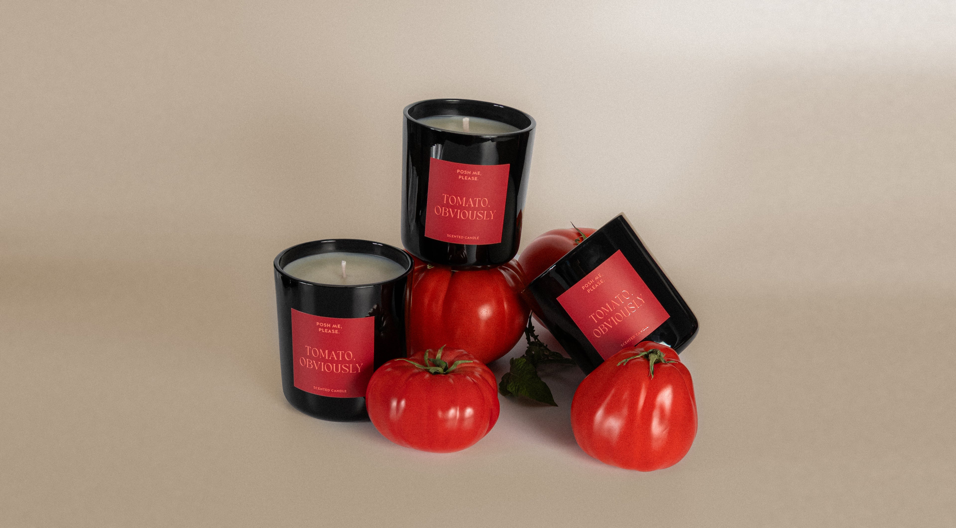 Tomato, Obviously candles in black glass vessels surrounded by fresh red tomatoes, neutral background