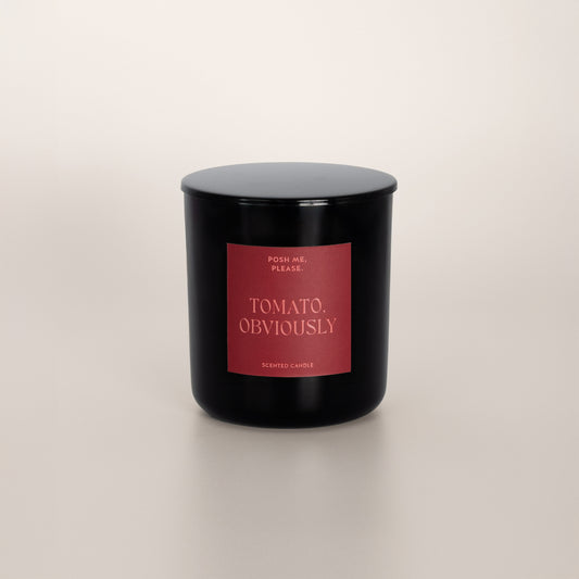 Tomato, Obviously black glass candle with deep red label by POSH ME, PLEASE.,
lid on, light background