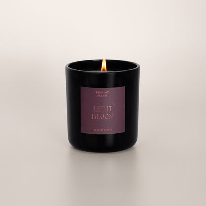 Lit Let It Bloom candle with flame, tuberose jasmine scent, neutral background